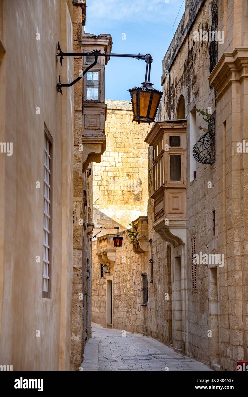 A view of old Mdina street with a traditional Maltese style openwork balconies, Mdina city - old capital of Malta Stock Photo