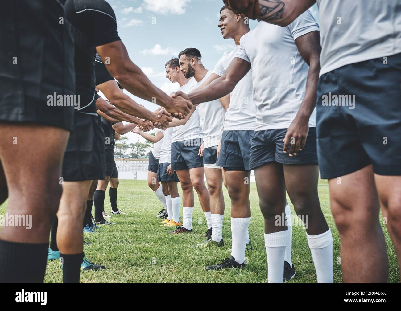 Good game. a group of young rugby players shaking each others hands to congratulate in playing a good game outside on a filed. Stock Photo