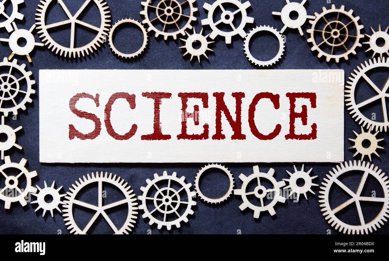 The word SCIENCE written in red on a black and white background near the pen Stock Photo