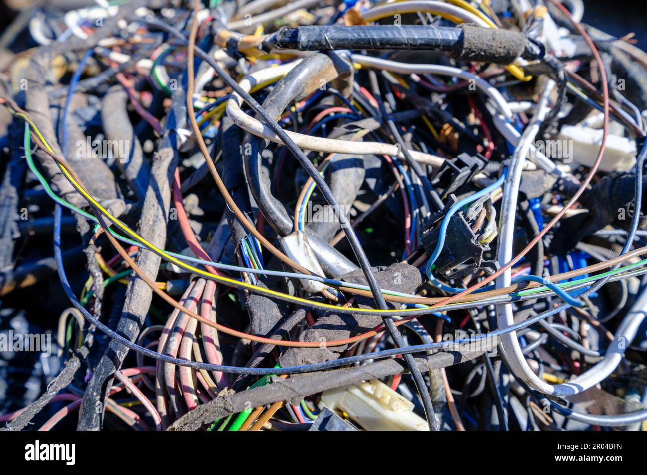 Pile of electrical wires of old cars in a junkyard. recycling Stock