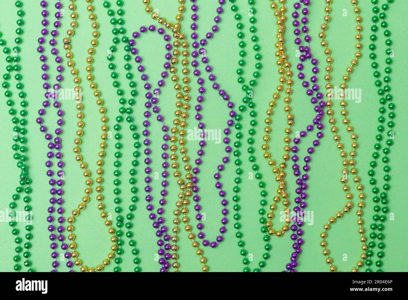 Mardi Gras bead on green background. Horizontal festival and sport