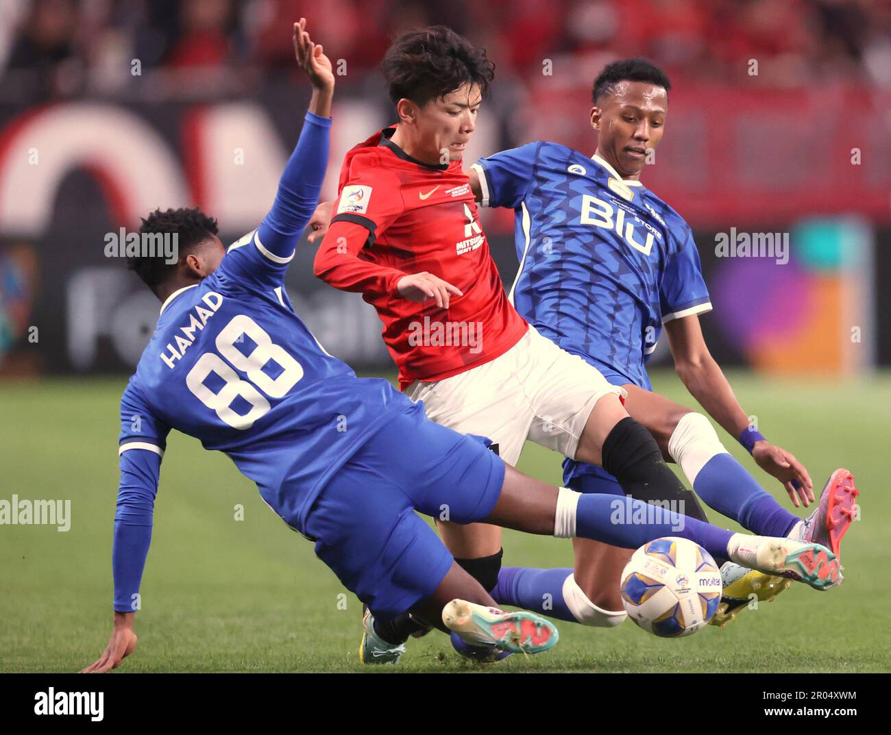 Al Hilal's Ali Al Bulayhi, right, fights for the ball with Urawa