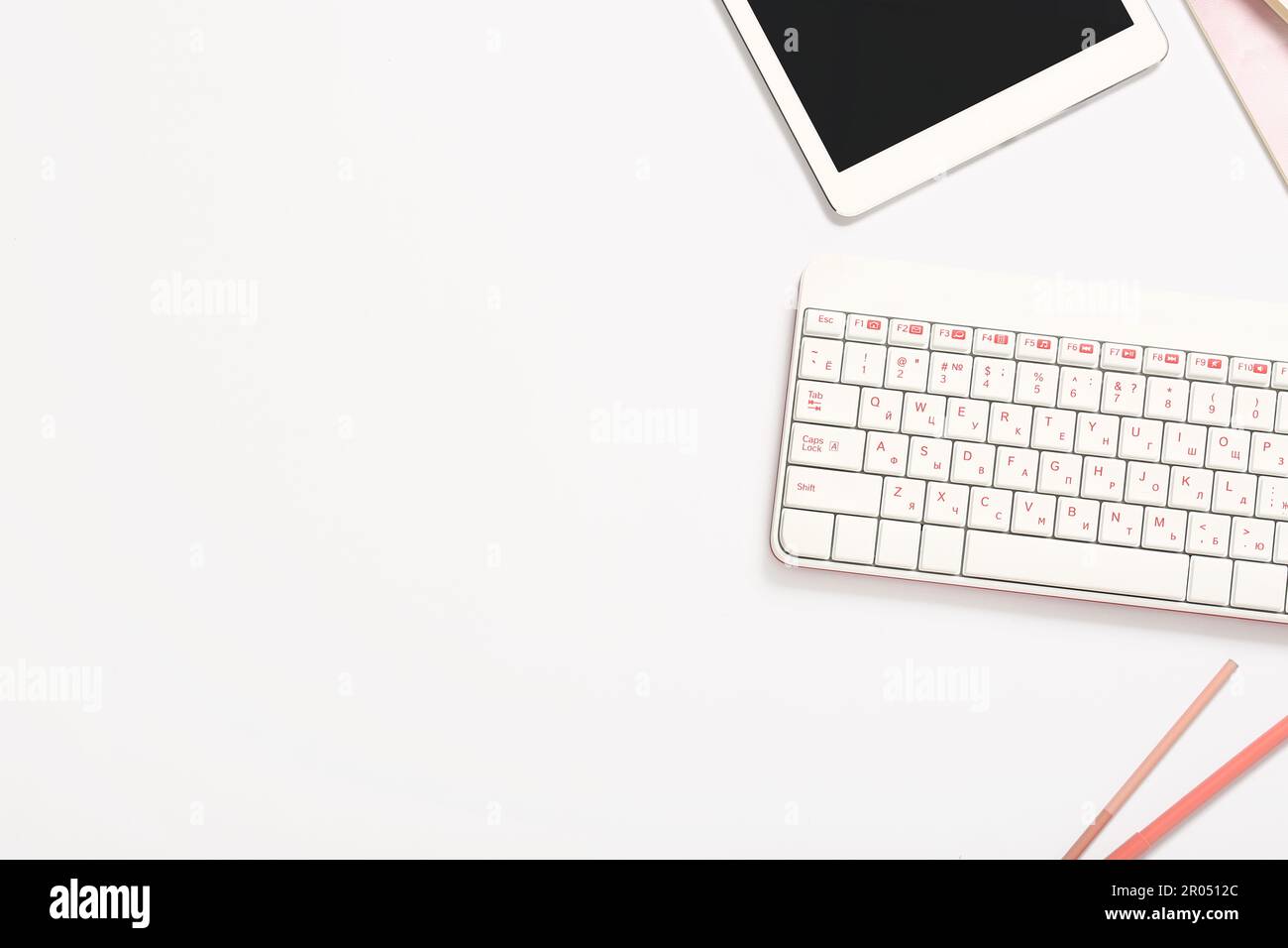 Composition with keyboard, pens and tablet computer on white background Stock Photo