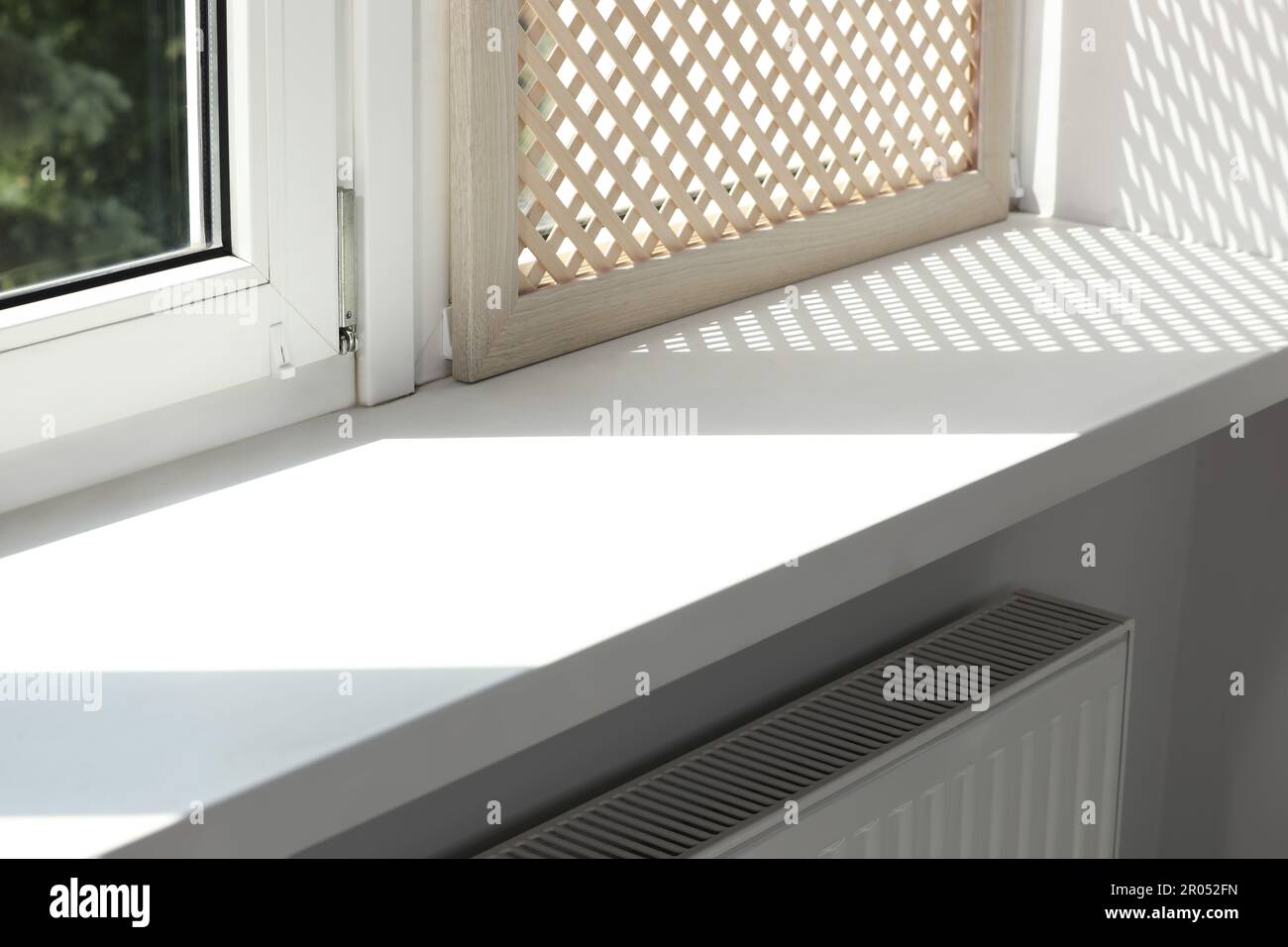 Empty white window sill and decorative wooden shutter indoors Stock