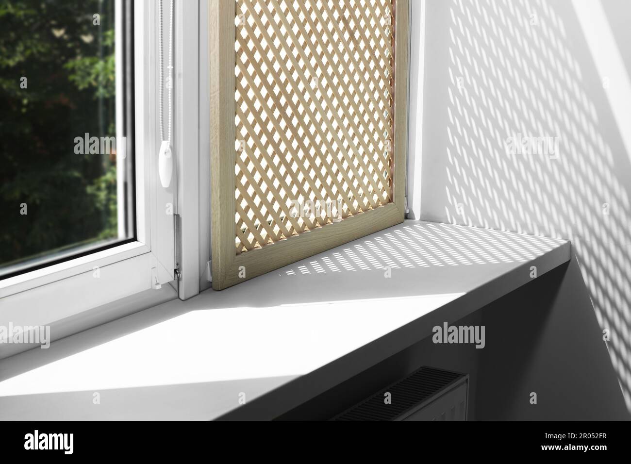 Empty white window sill and decorative wooden shutter indoors Stock