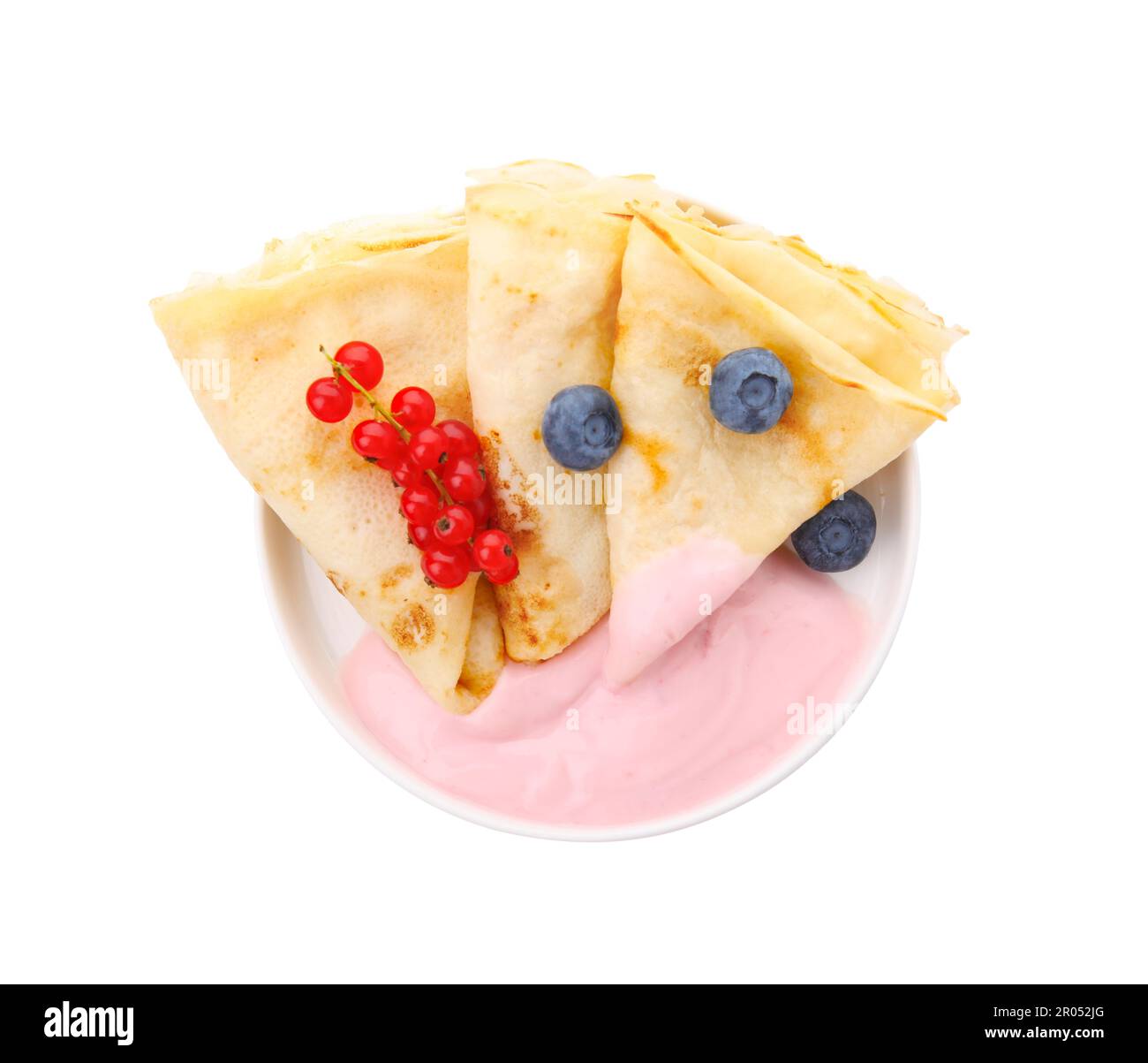 Delicious crepes with natural yogurt, blueberries and red currants on white background, top view Stock Photo