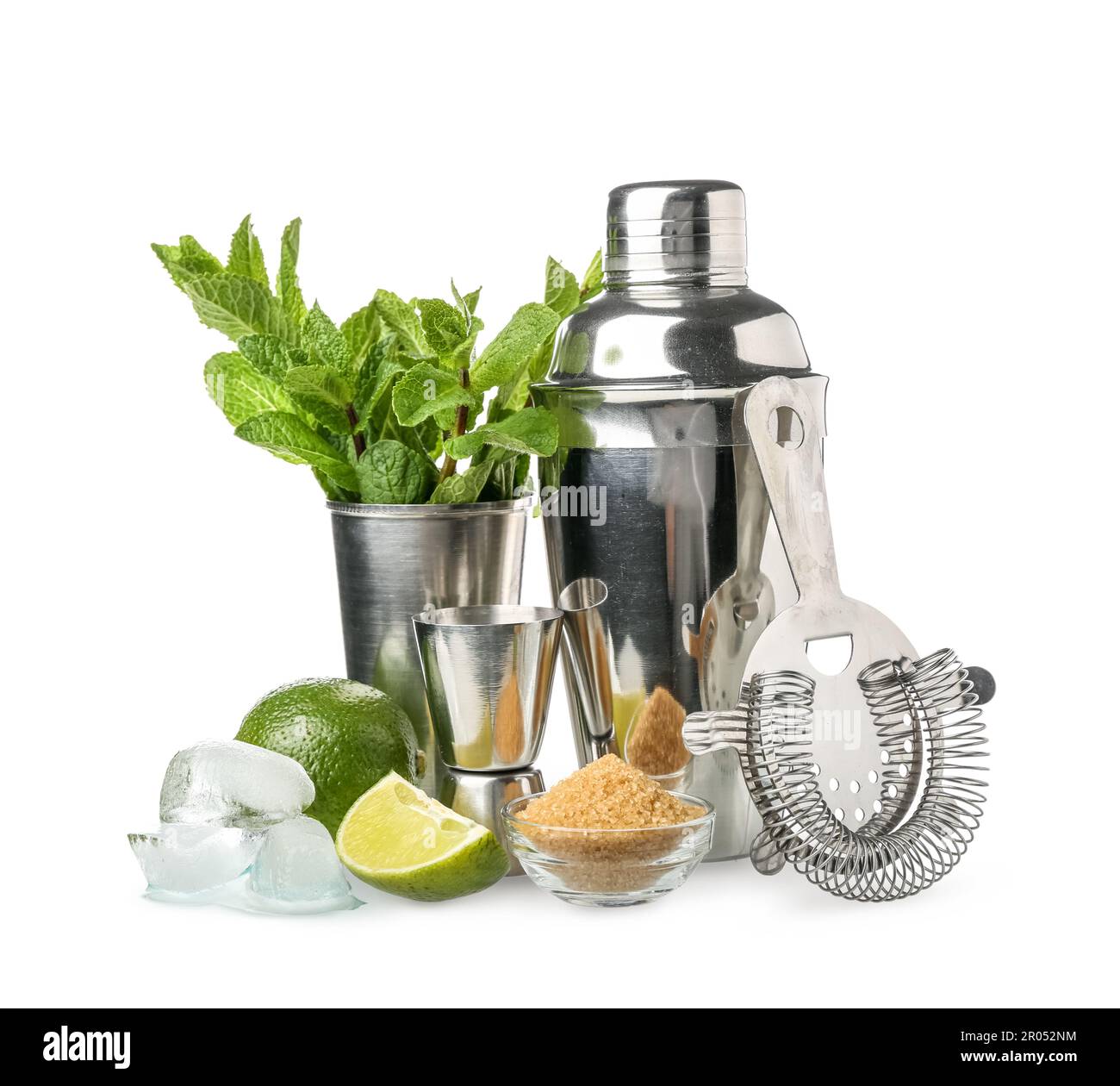 Shaker, strainer, measure cup and ingredients for preparing mojito on