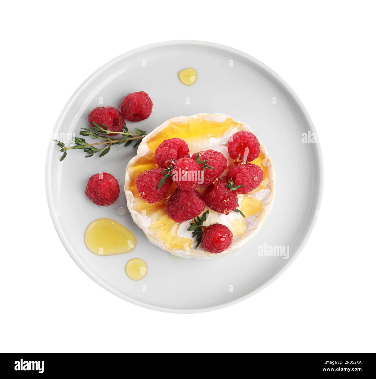 Brie cheese served with raspberries and honey isolated on white, top ...
