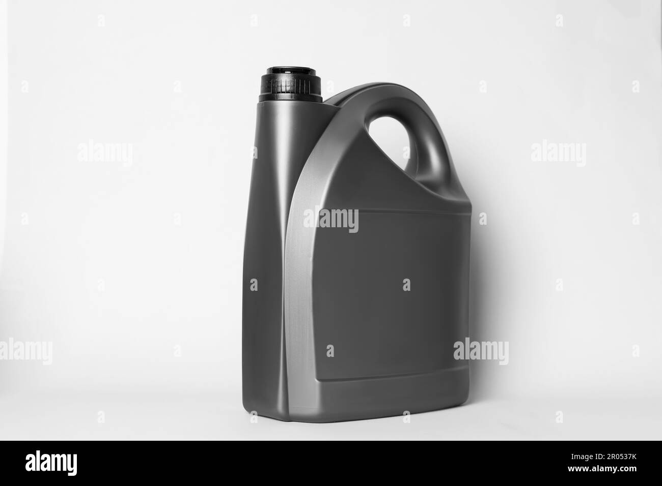 Motor oil in grey canister on light background Stock Photo Alamy