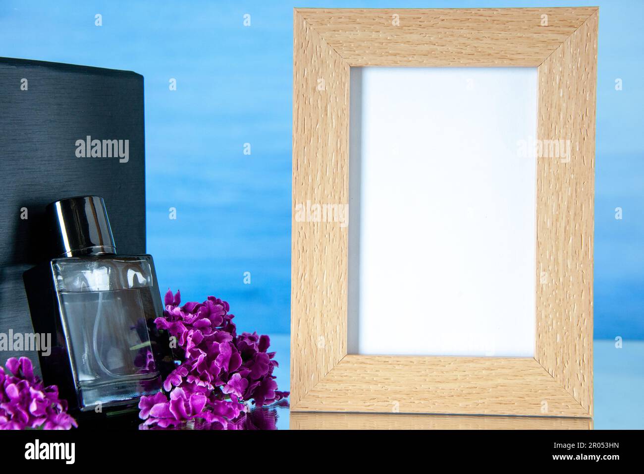Computer Frame Perfume front view expensive perfume with picture frame on light blue ...