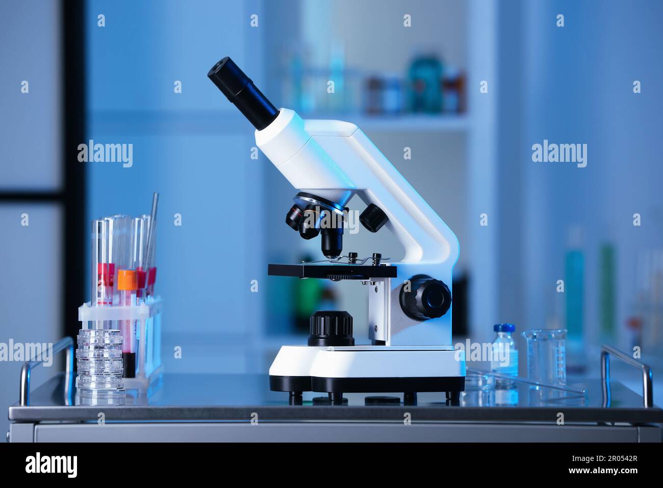 Modern medical microscope on gray table in laboratory Stock Photo - Alamy