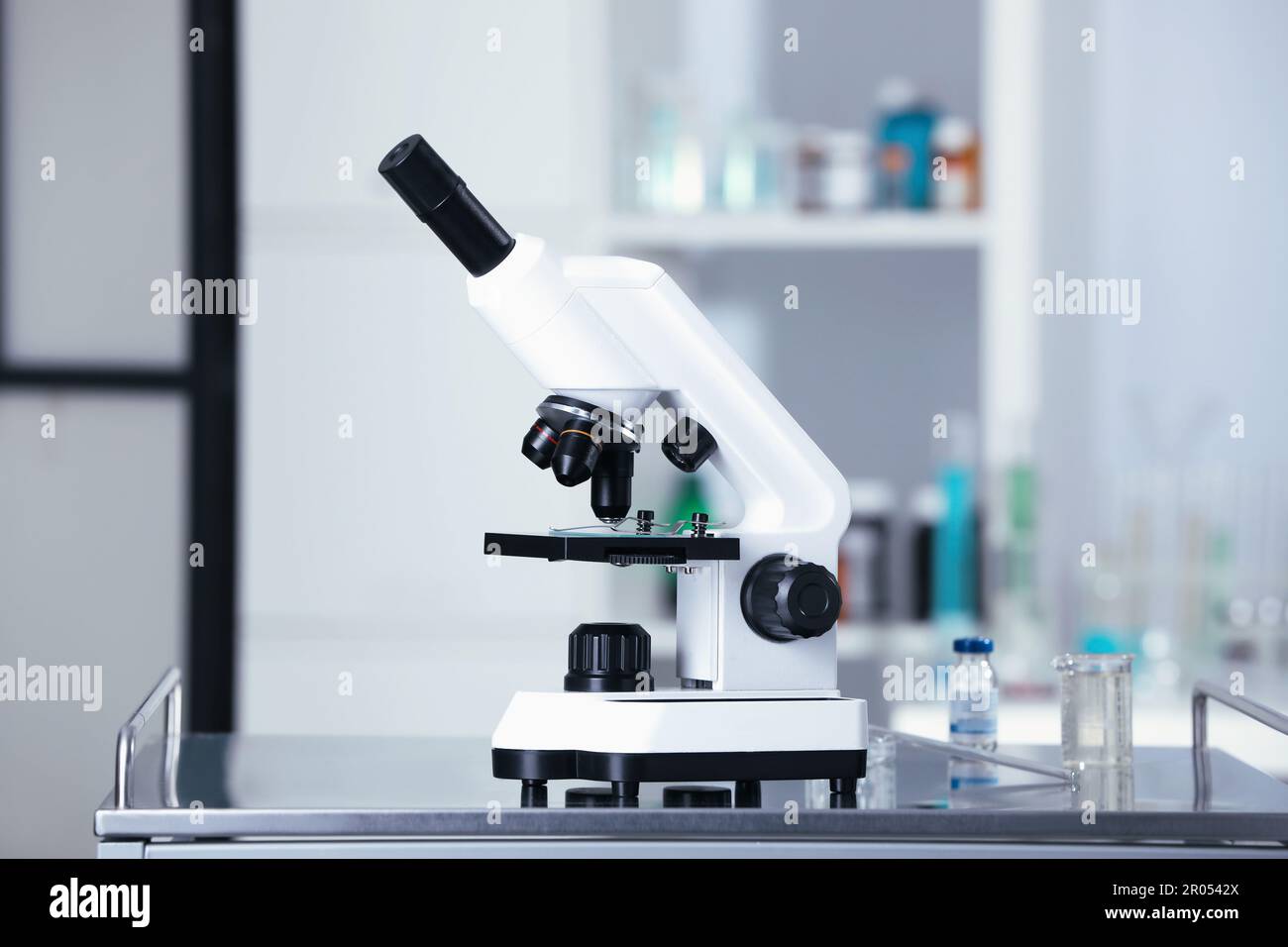 Modern medical microscope on gray table in laboratory Stock Photo - Alamy