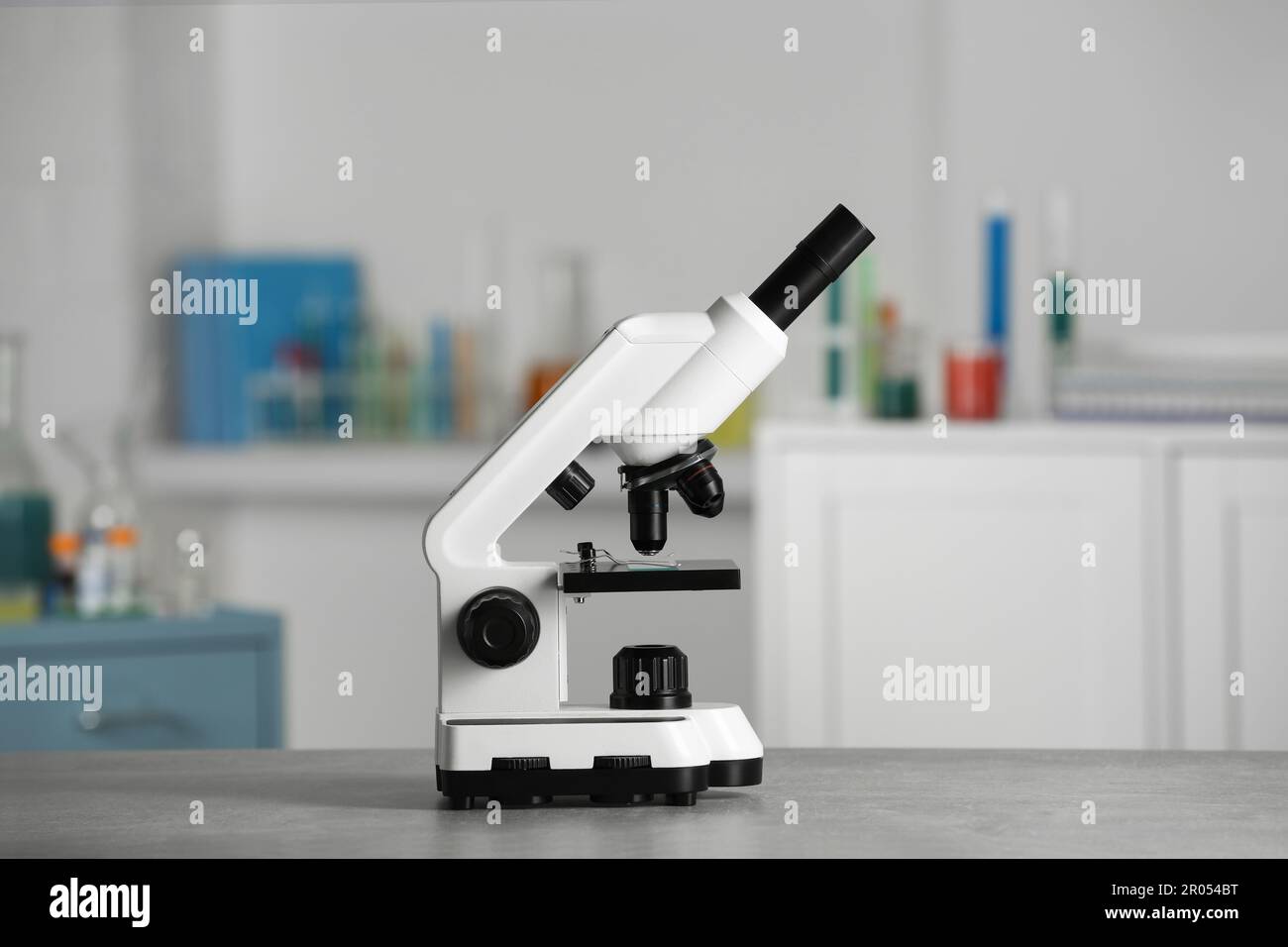Modern medical microscope on grey table in laboratory Stock Photo - Alamy