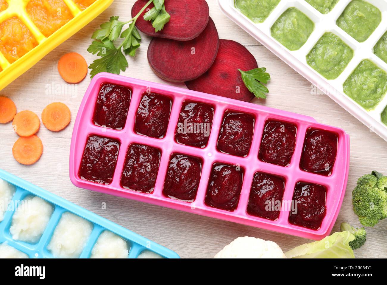 https://c8.alamy.com/comp/2R054Y1/different-purees-in-ice-cube-trays-and-ingredients-on-white-wooden-table-flat-lay-ready-for-freezing-2R054Y1.jpg