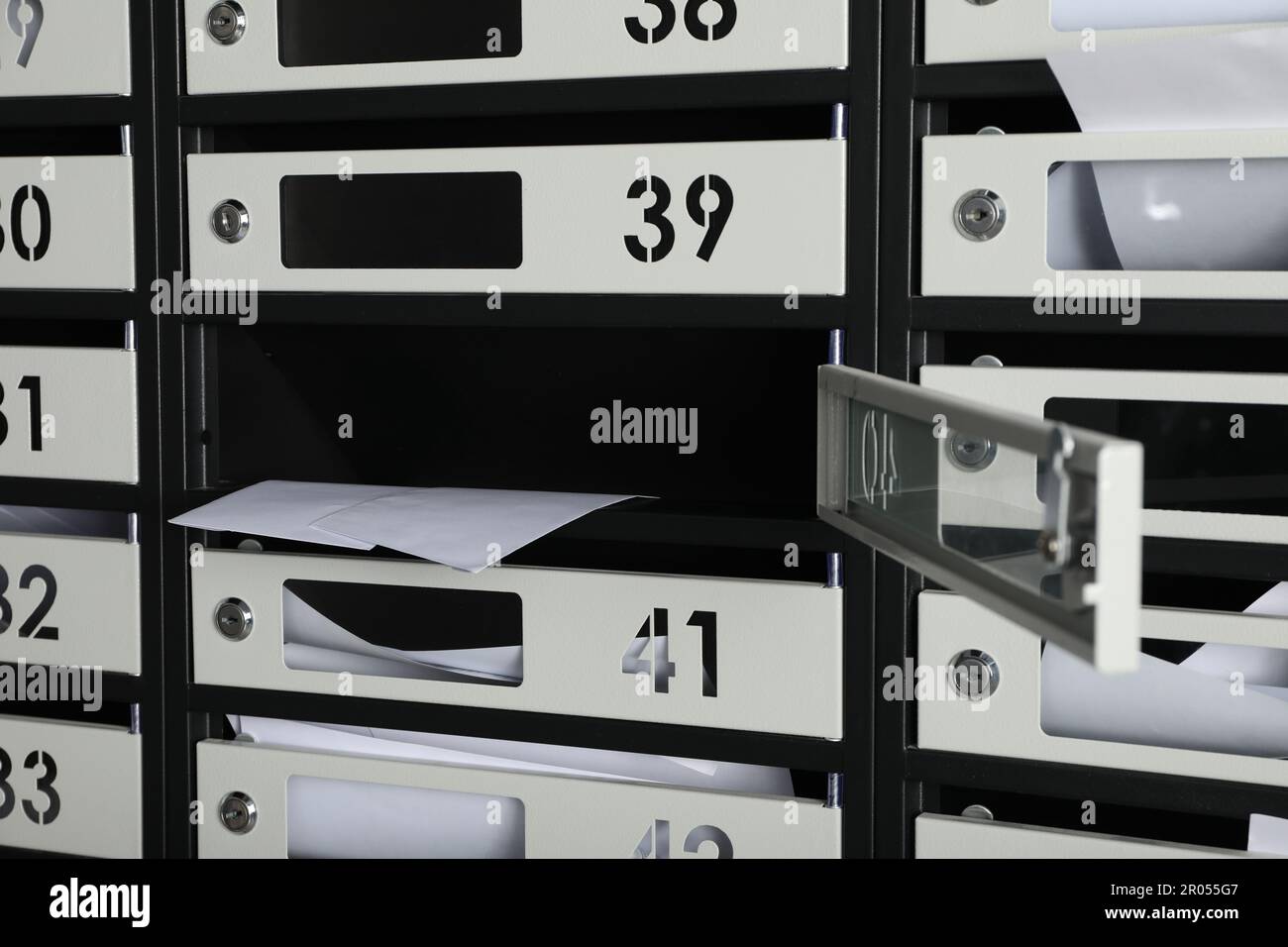 Open mailbox with keyhole, number and receipts, closeup Stock Photo Alamy