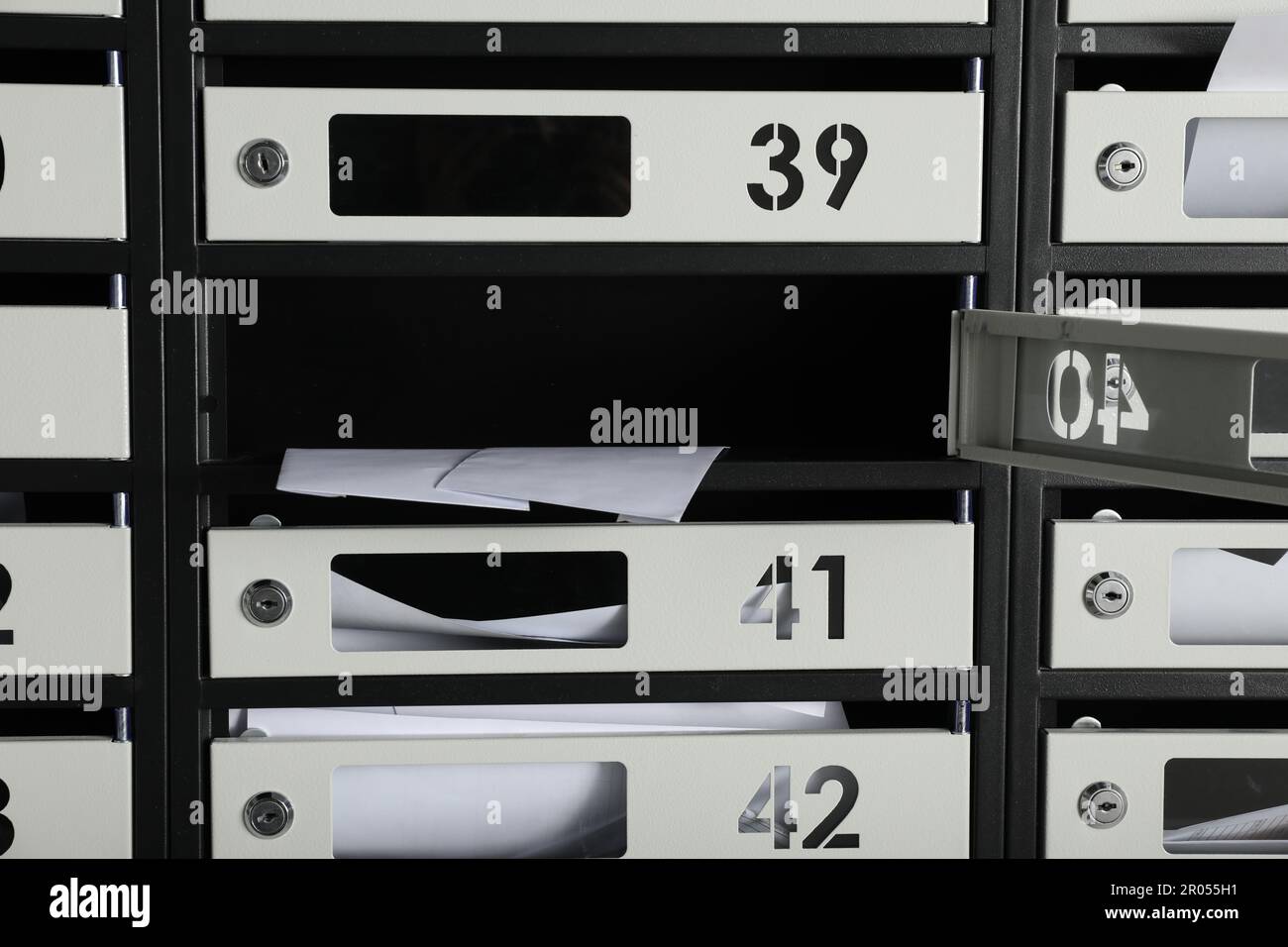 Open mailbox with keyhole, number and receipts Stock Photo Alamy