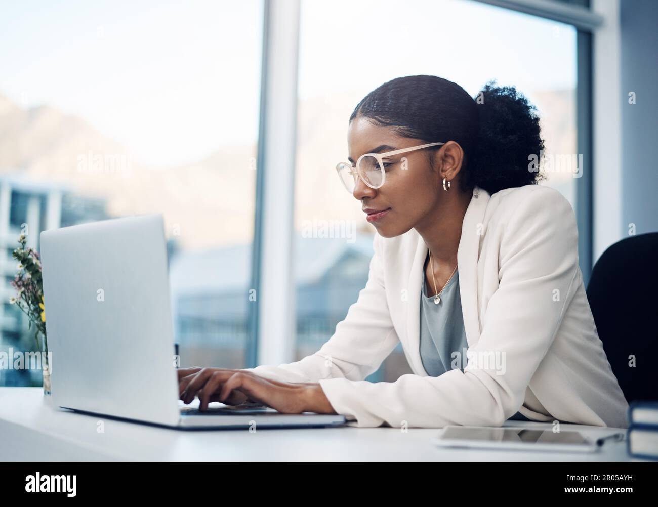 True ambition cant be broken. a young businesswoman using a laptop at her desk in a modern office. Stock Photo