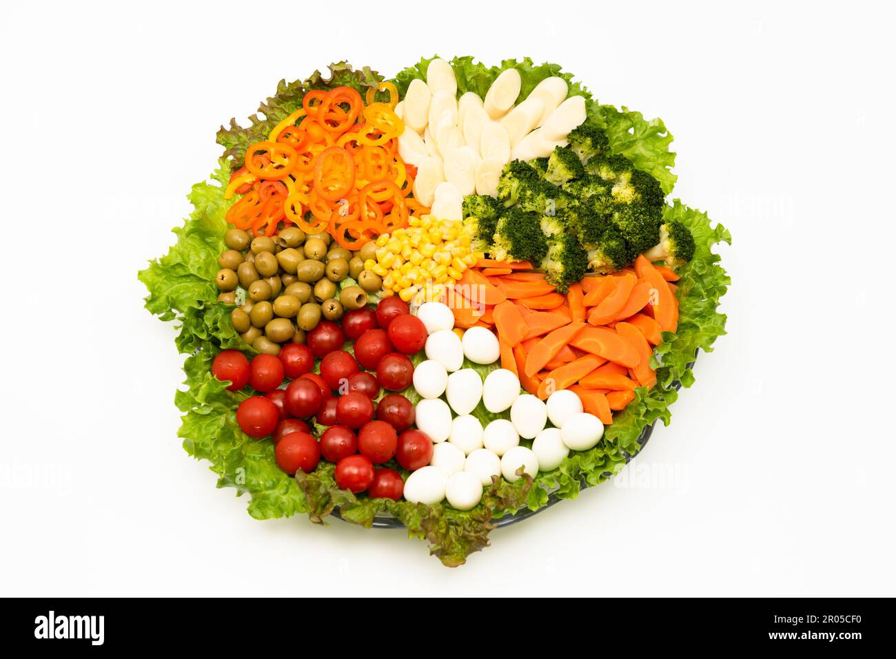 Delicious and healthy lettuce salad with various vegetables and quail