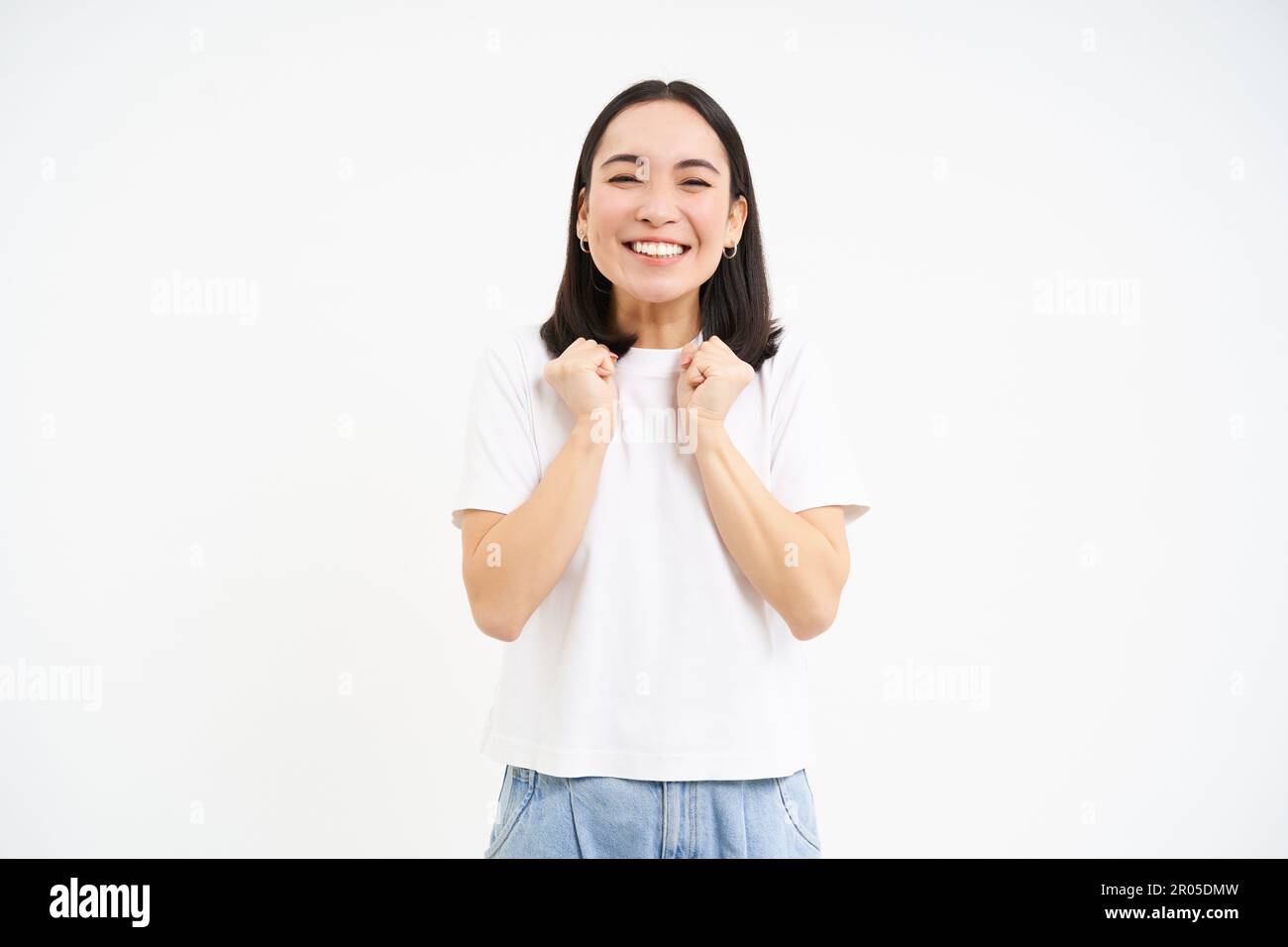 Excited, super happy asian woman jumping from joy, standing over