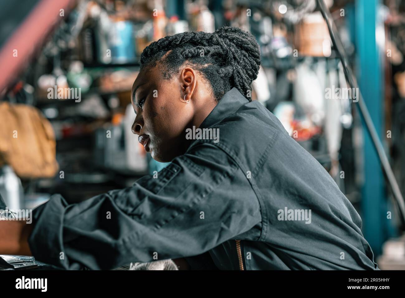 Experienced auto mechanics inspect car battery terminals and voltage to