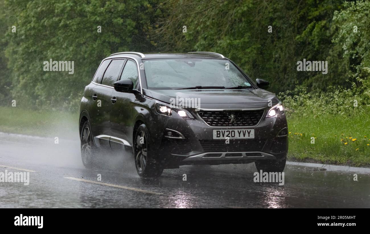 Stony Stratford,Bucks,UK - May 6th 2023. 2020 PEUGEOT 5008 driving in the rain on a wet road Stock Photo