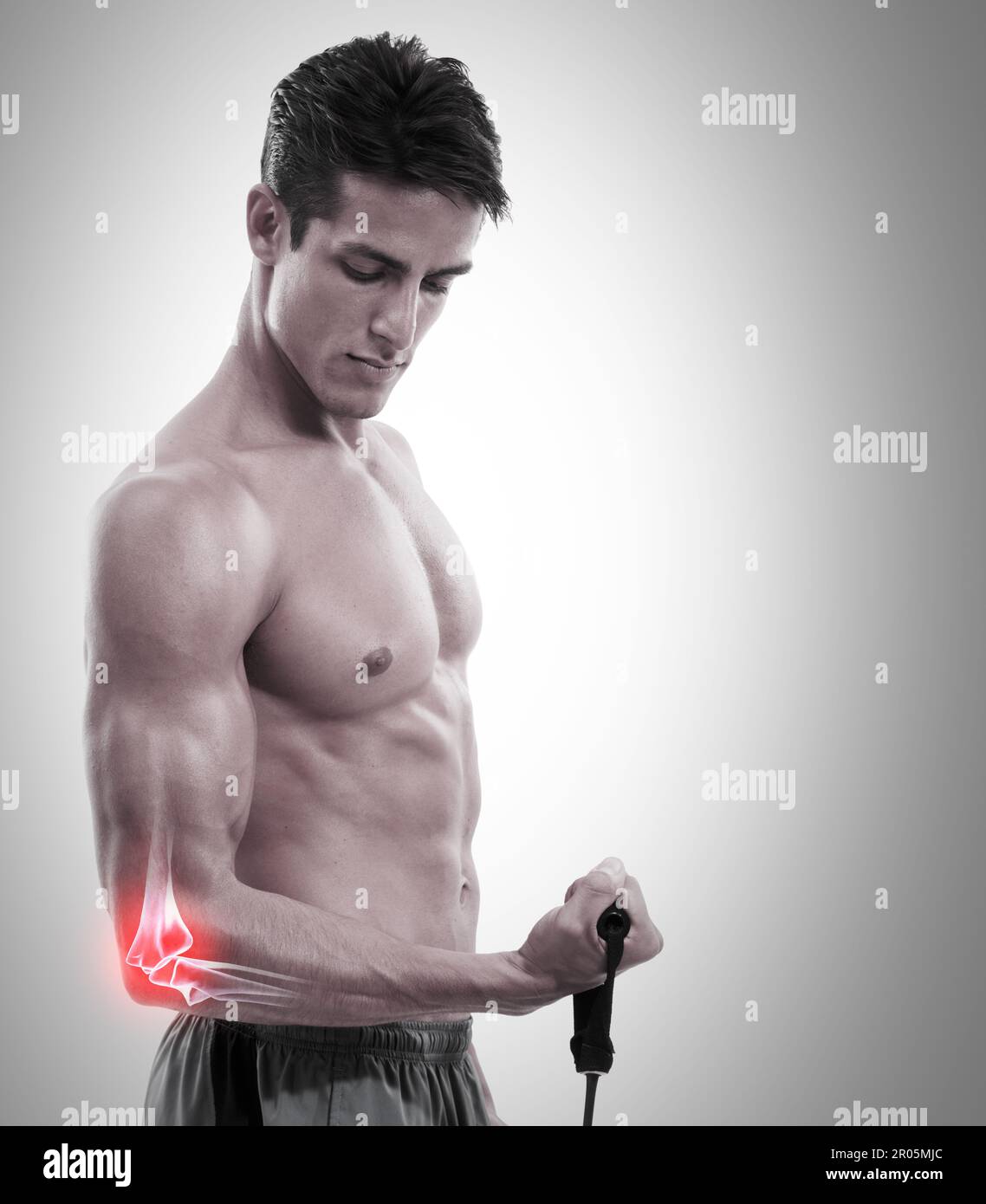 Man, elbow and x ray in weightlifting injury, workout or exercise against a gray studio background. Muscular male lifting weight with sore arm, ache Stock Photo