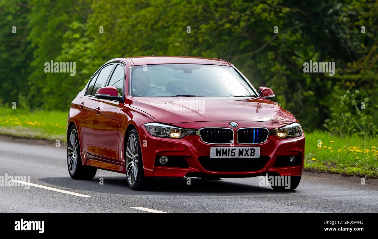 Stony Stratford,Bucks,UK - April 30th 2023. 2015 red diesel engine BMW 3 series car travelling on an English country road. Stock Photo
