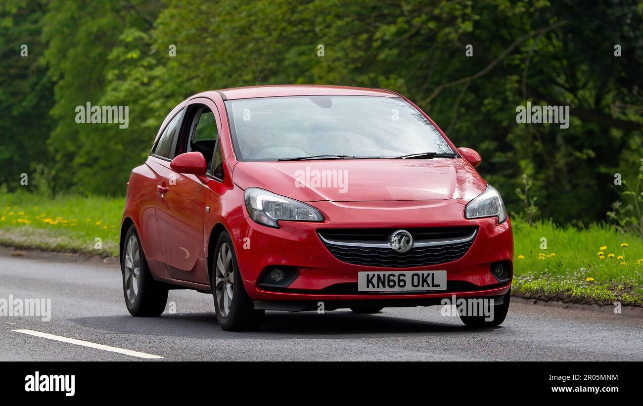 Stony Stratford,Bucks,UK - April 30th 2023.  2016 red VAUXHALL CORSA travelling on an English country road Stock Photo
