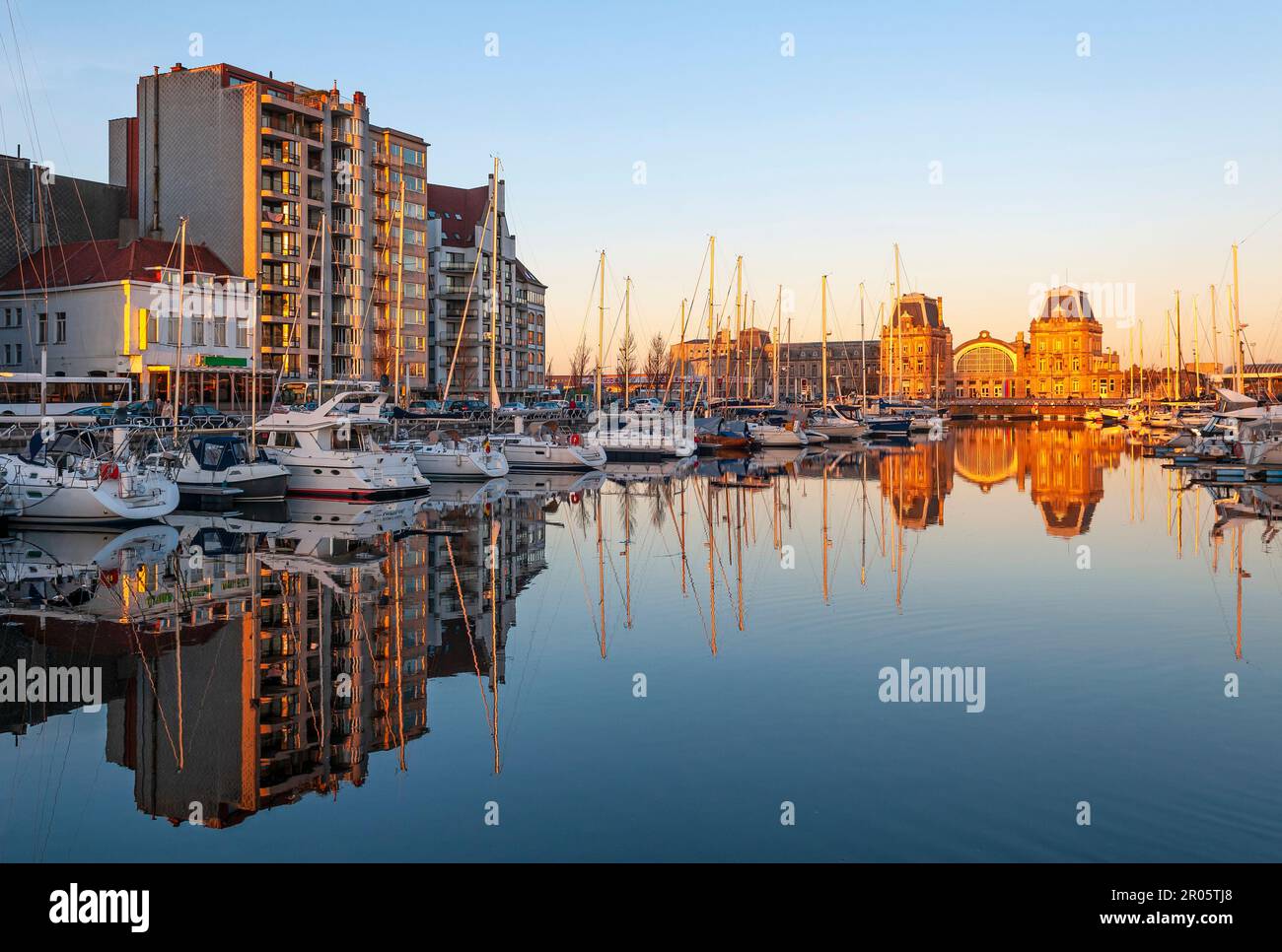 Oostend train station and yacht harbour at sunset, Oostende (Ostend), Belgium. Stock Photo