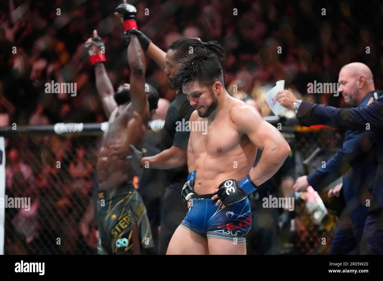 Henry Cejudo, right, reacts after losing to Aljamain Sterling, of