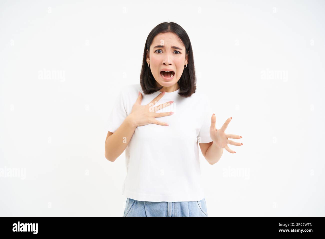 Image of scared asian woman, looking worried and concerned, terrified  shouting, standing over white background Stock Photo - Alamy