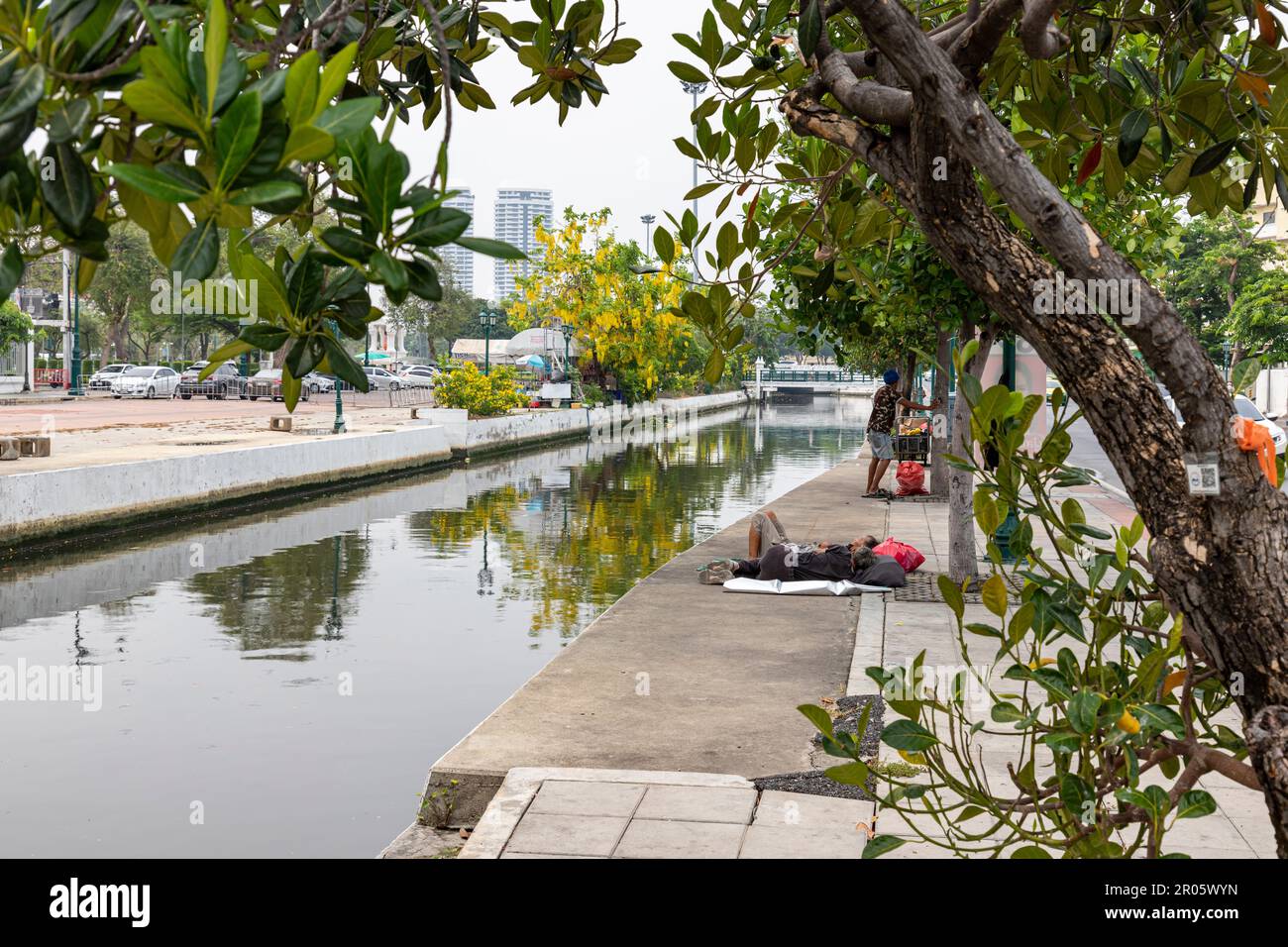 Bangkok,Thailand - April 16, 2023: If coming to Bangkok, you will be able to see homeless people resting on the sidewalks along the Khlong Lot. in fro Stock Photo