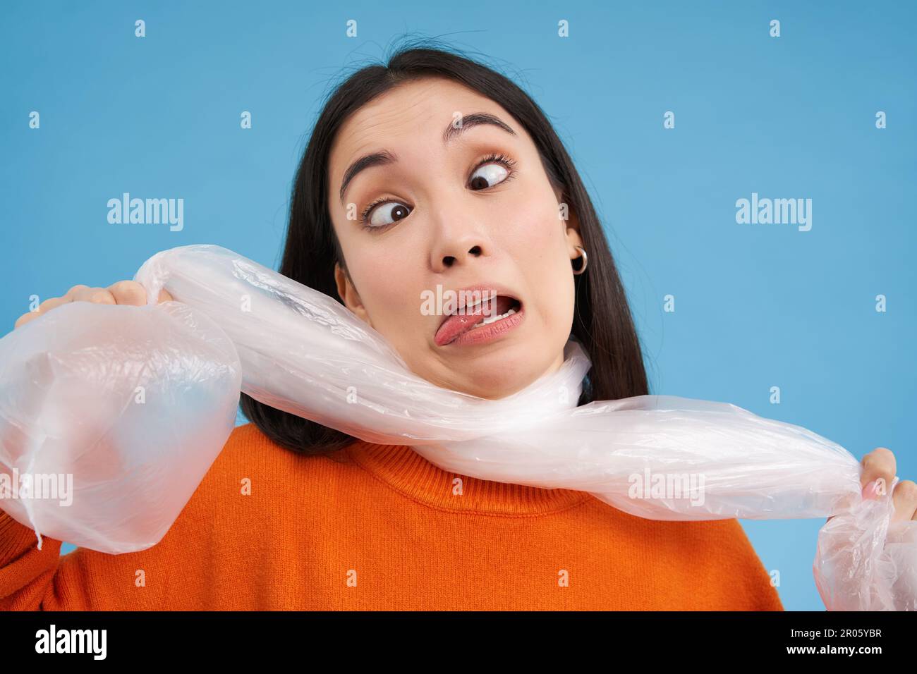 Woman suffocating, being choked by plastic bag, concept of ecology ...