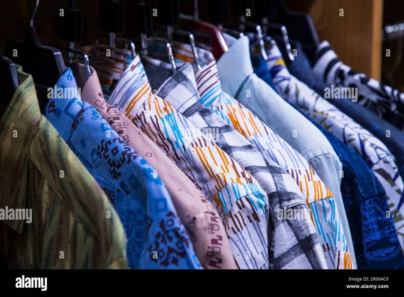 Colorful variety of Shirt  hangings in a clothing Showroom. Close-up Focus Stock Photo