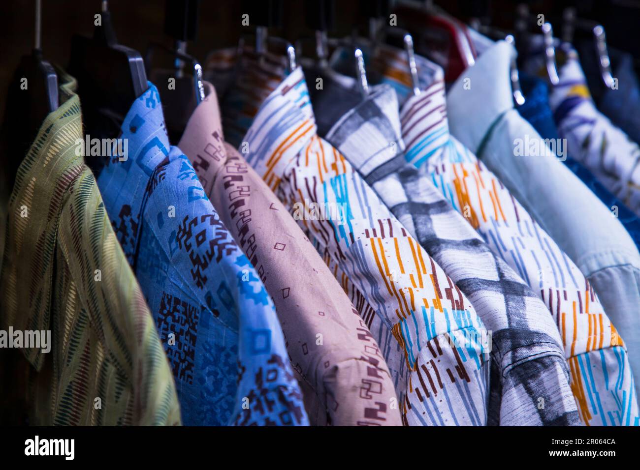 Colorful variety of Shirts  hangings in a clothing Showroom. Cluse-up Focus Stock Photo