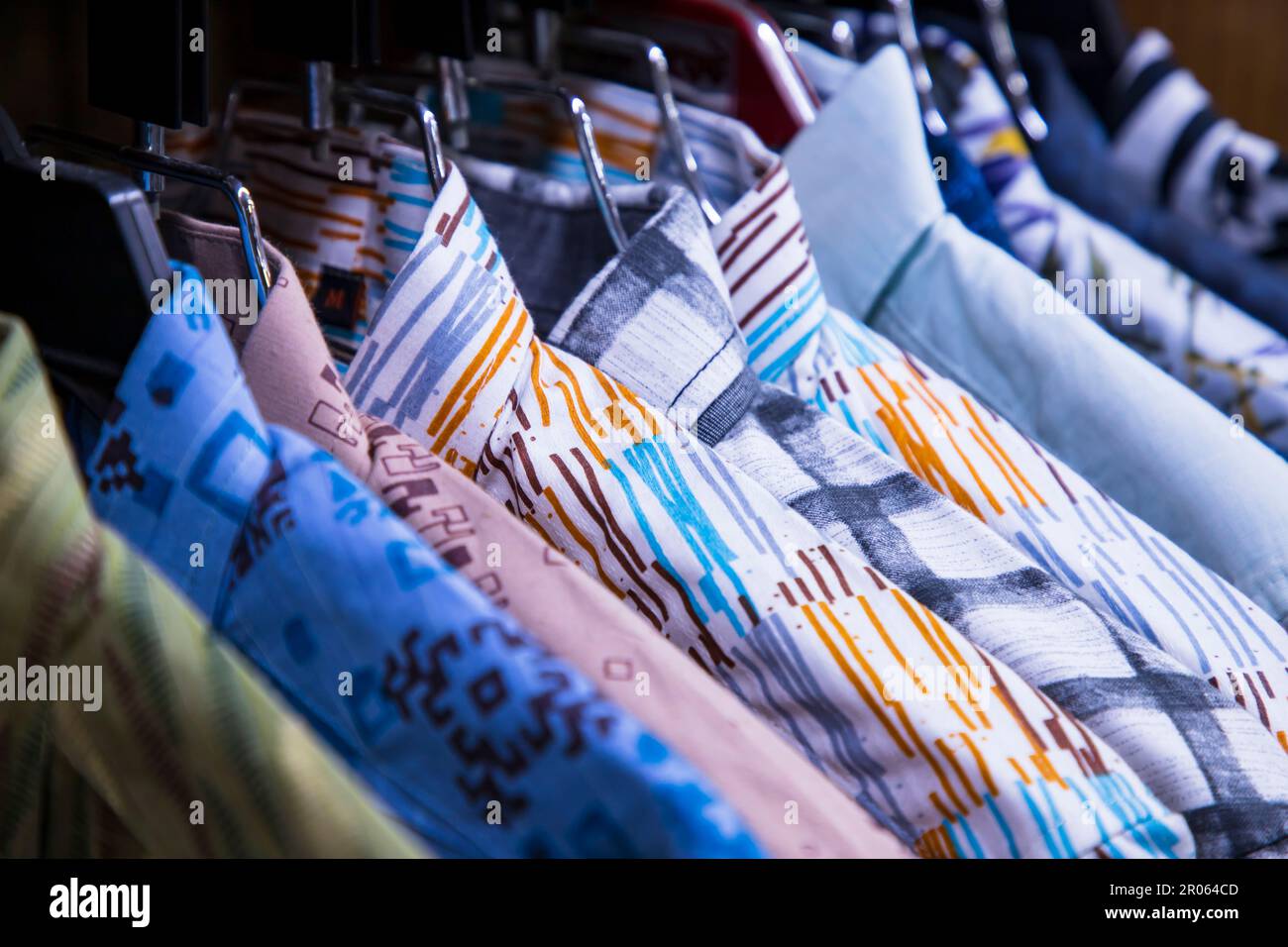 Colorful variety of Shirt  hangings in a clothing Showroom. Close-up Focus Stock Photo