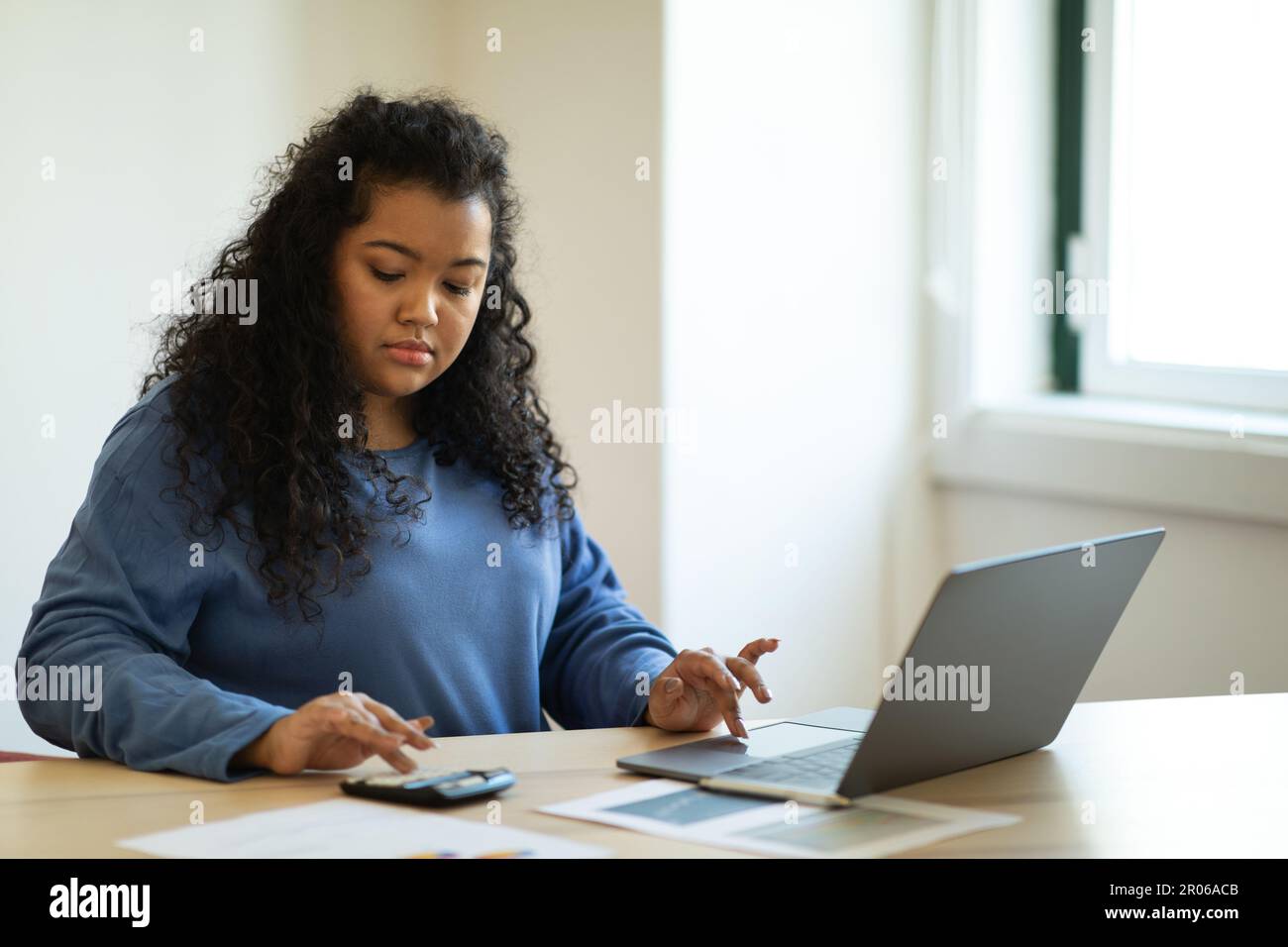 Young hispanic woman accountant working from home office Stock Photo