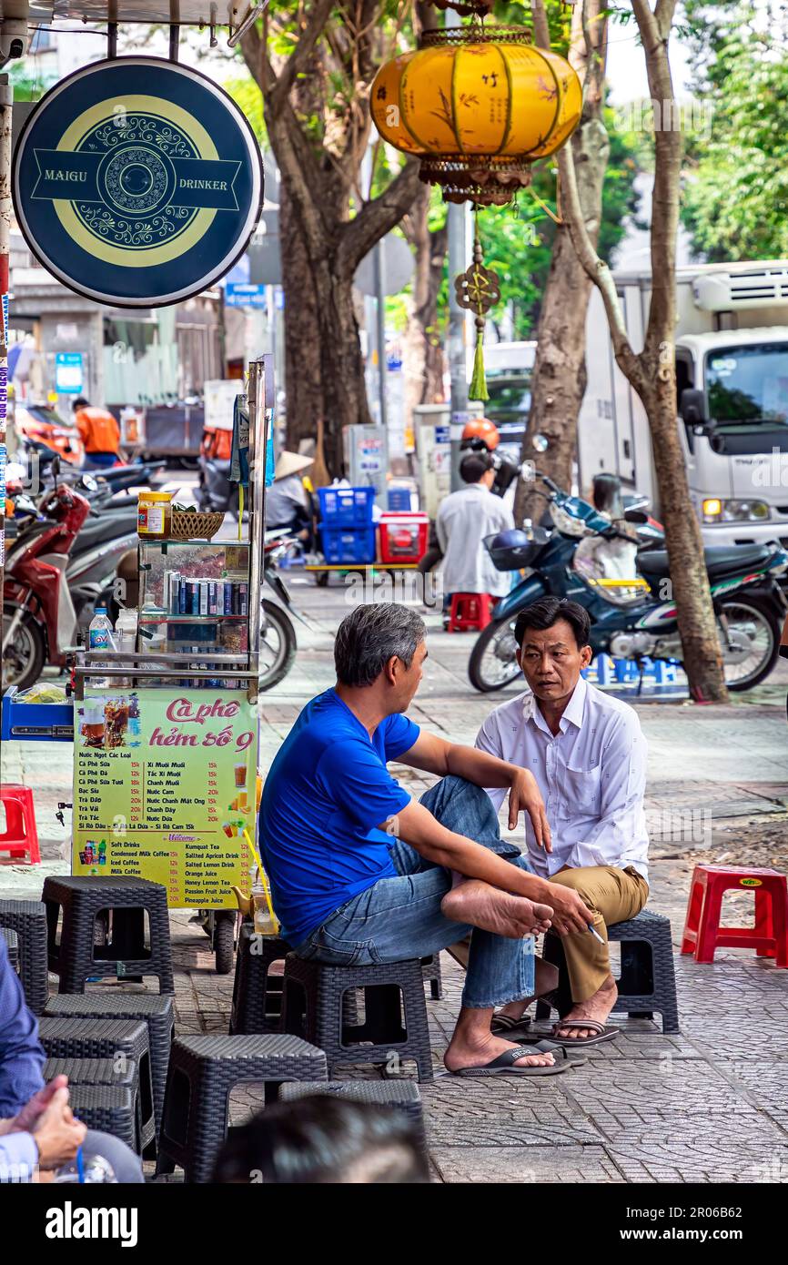 Vietnamese men sitting at sidewalk coffee shop for breakfast Ho Chi Vietnamese men sitting at sidewalk coffee shop for breakfast Ho Chi