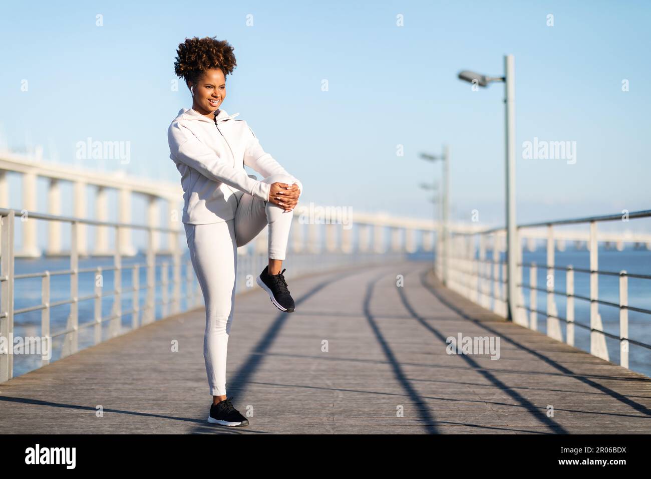 Outdoor Fitness Routine. Motivated Young Black Woman Stretching Muscles