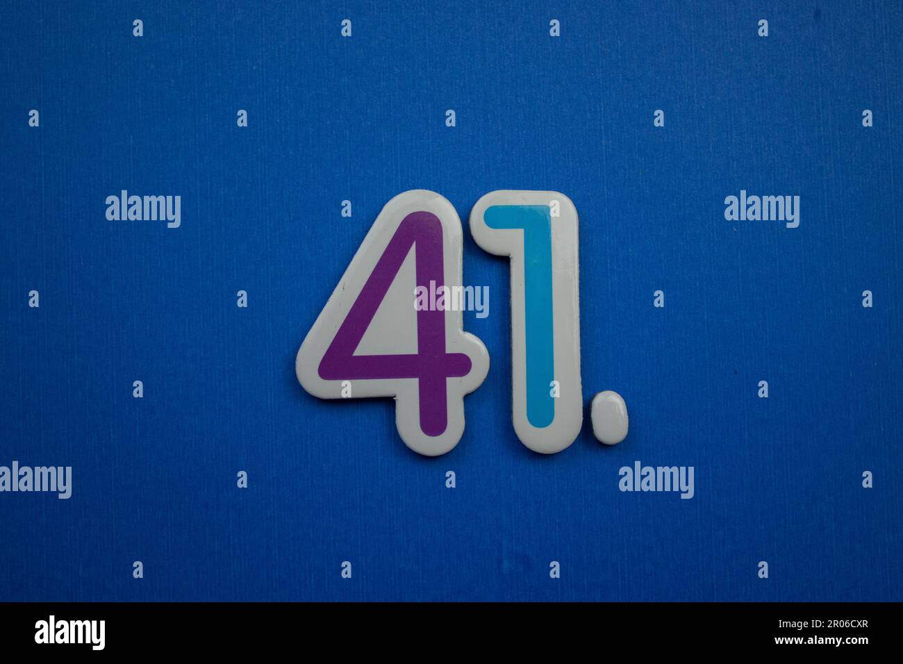 The number 41 placed on a blue background photographed from above The number 41 placed on a blue background photographed from above