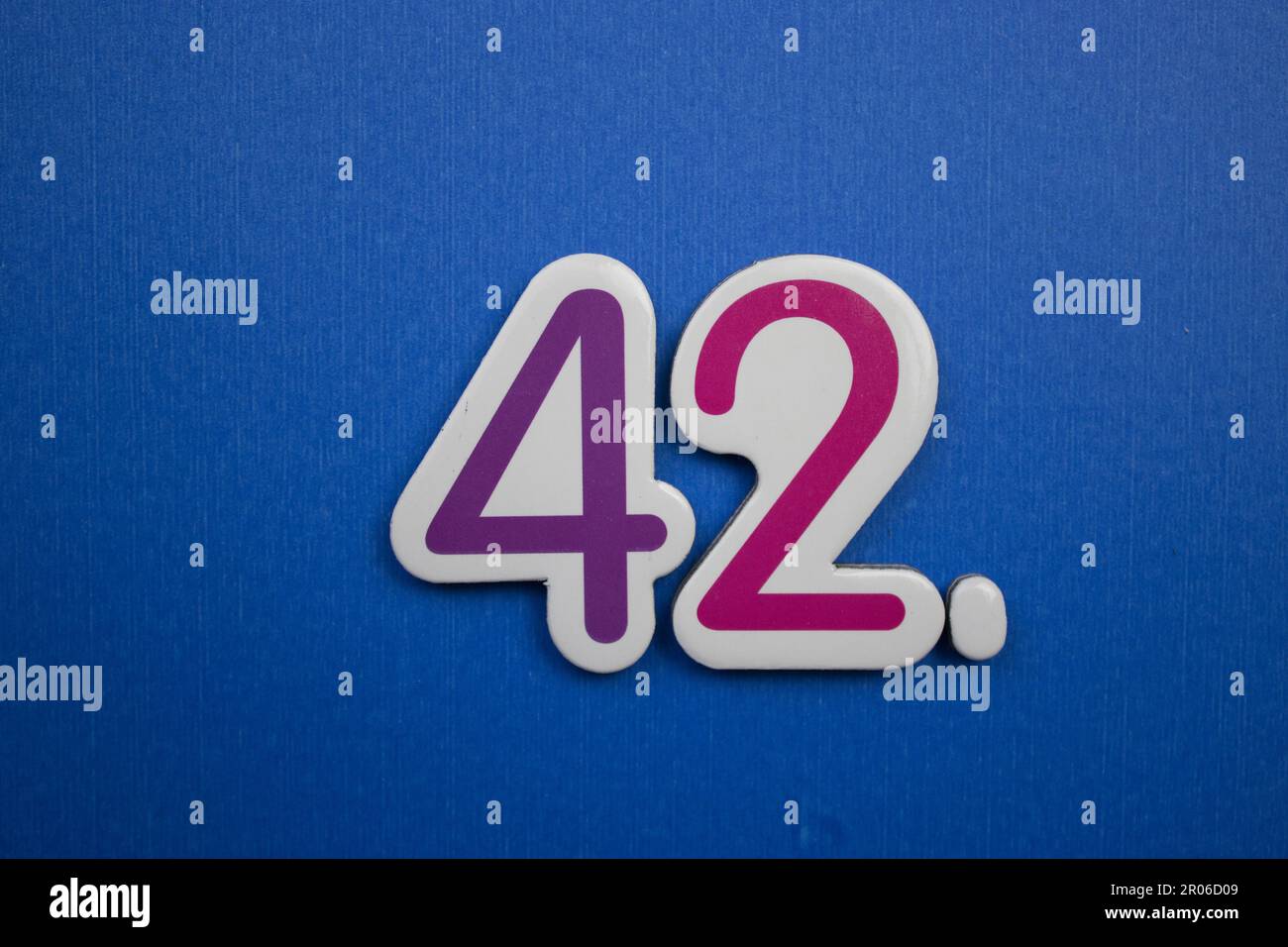 The number 42 placed on a blue background photographed from above The number 42 placed on a blue background photographed from above