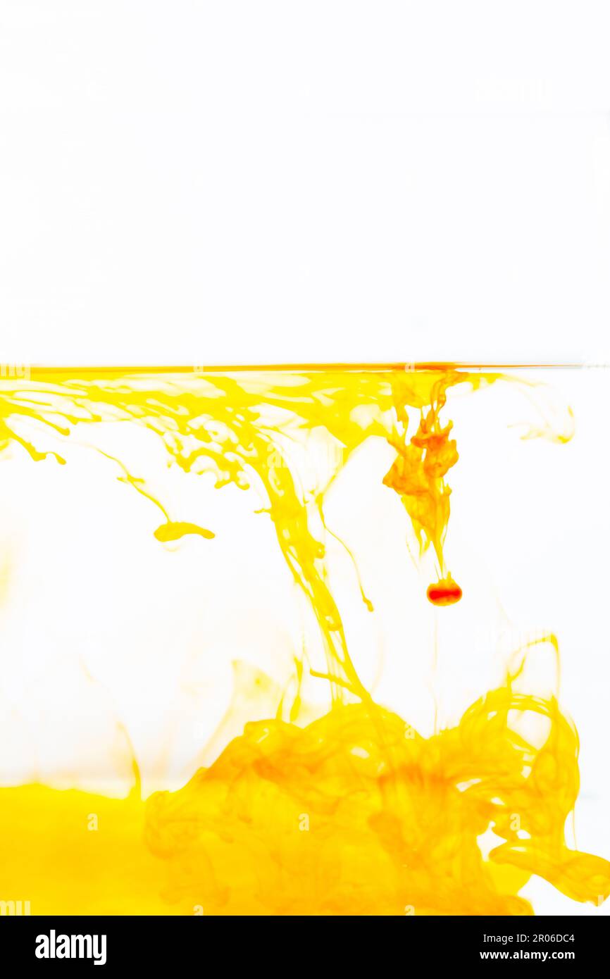 Orange ink drop in water, abstract orange ink in water on white