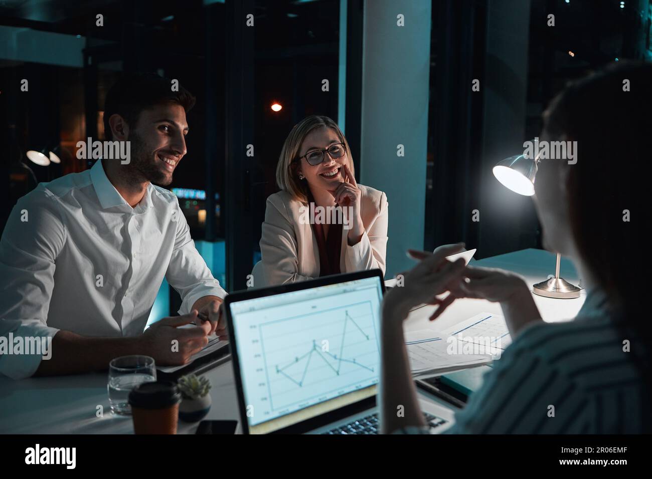Slaying the deadline with teamwork and hard work. colleagues having a meeting during a late night in a modern office. Stock Photo