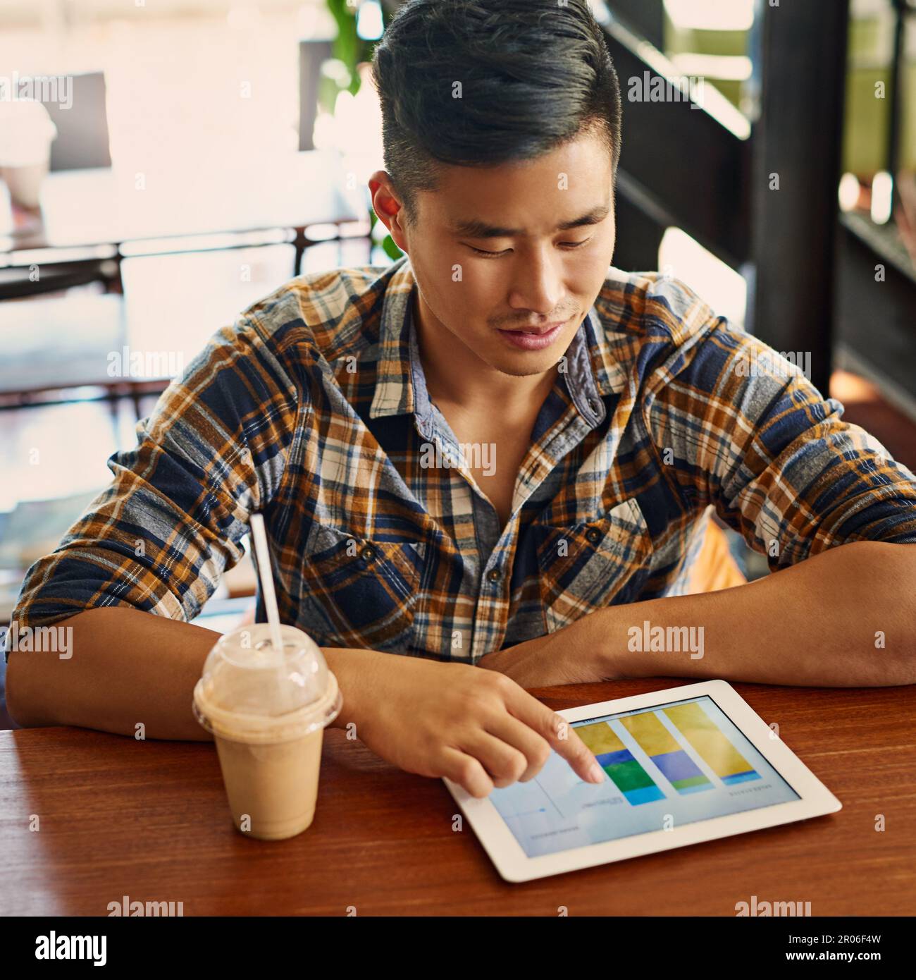 Tracking all his progress online. a young designer using a digital tablet in an office. Stock Photo