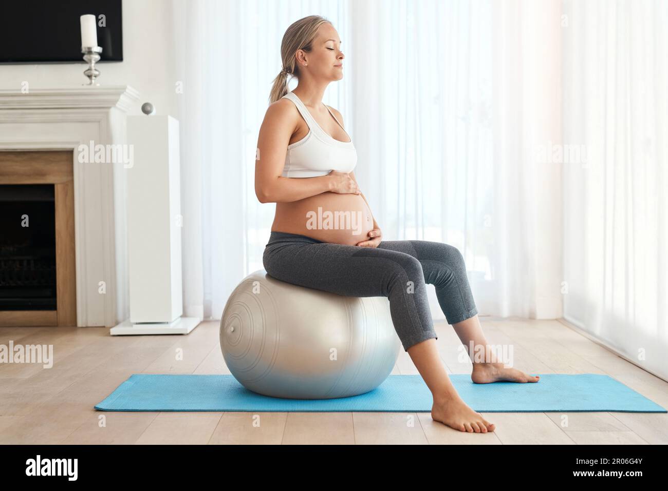 Keeping her muscles in shape for labour. a pregnant woman working out