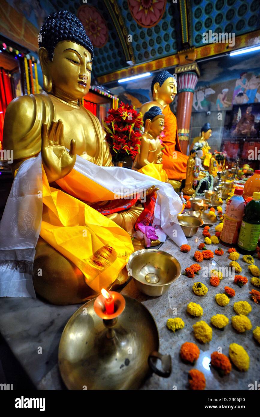 Kolkata, India. 05th May, 2023. A lit candle seen in front of a statue
