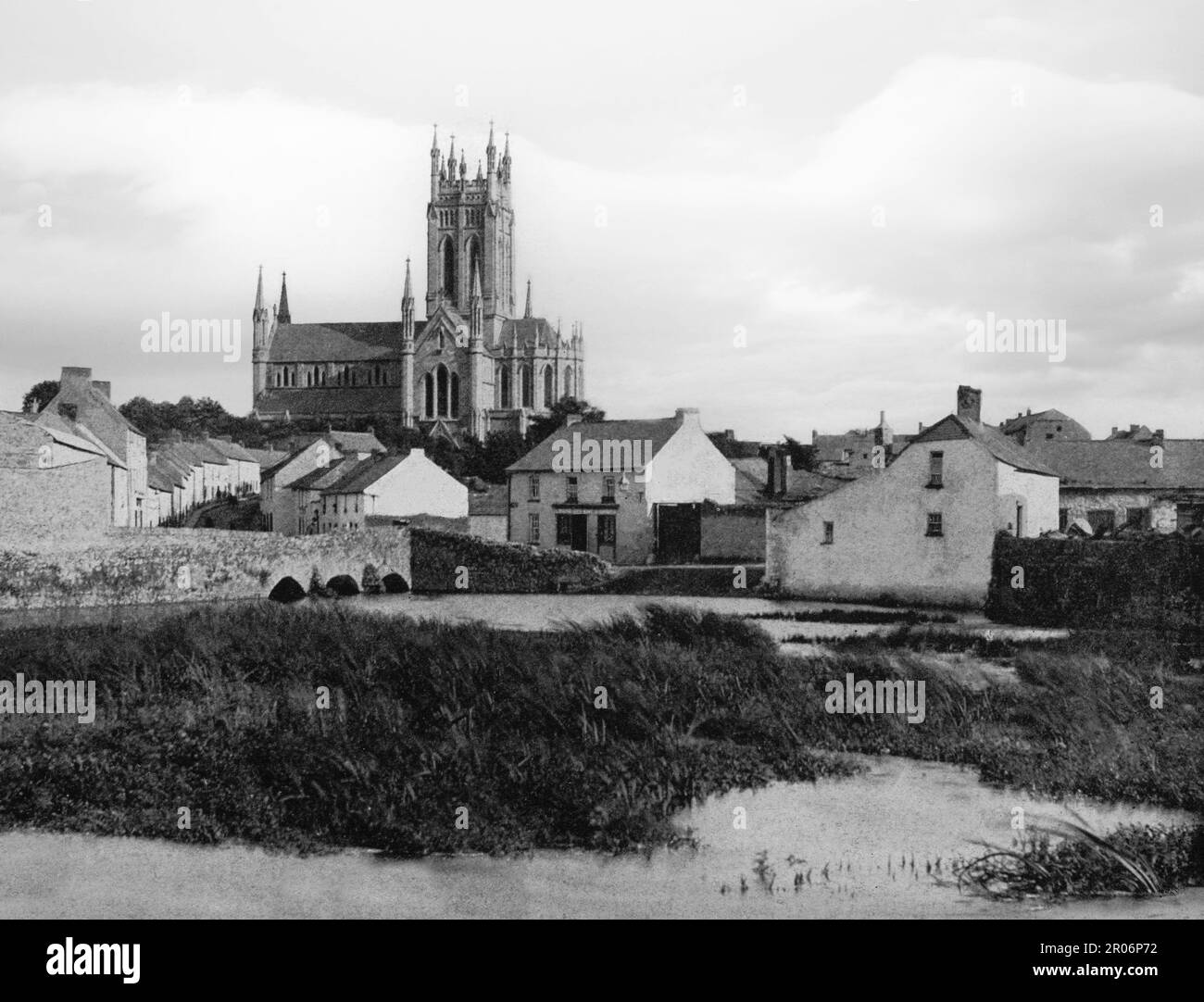 A late 19th century view of St Mary's Roman Catholic church, aka 'the church of St Kieran' and 'the Cathedral of the Assumption' in the Irish city of Kilkenny in County Kilkenny, Ireland on both banks of the River Nore. Designed by William Deane Butler (c.1794-1857) in 1842, from cut-limestone which was sourced locally, the cathedral has a cruciform plan and its style is described as ‘Early English Gothic’. Stock Photo