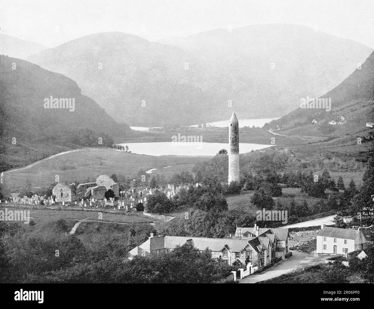 A late 19th century view of Glendalough, renowned for its Early Medieval monastic settlement founded in the 6th century by St Kevin in County Wicklow, Ireland.  Kevin, a descendant of one of the ruling families in Leinster, went to Glendalough with a small group of monks to found a monastery. The surviving buildings probably date from between the 10th and 12th centuries when the monastery included workshops, areas for manuscript writing and copying, guest houses, an infirmary, farm buildings and dwellings for both the monks and a large lay population. Stock Photo
