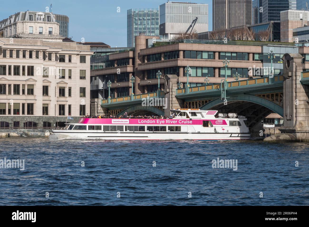 A London Eye River Cruise boat passing under Southwark Bridge on the ...
