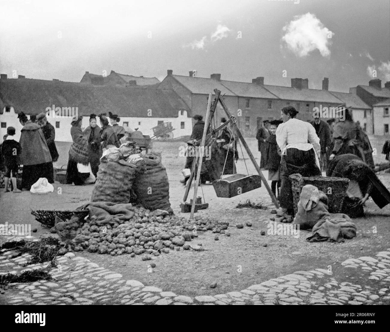 A late 19th century view of the Potato Market, in Bolton Square, in Drogheda, County Louth on the east coast of Ireland. The locals can be seen chatting and buying the ubiquitous spud. It was also the location for other markets selling butter, meat, fish and horses. Stock Photo